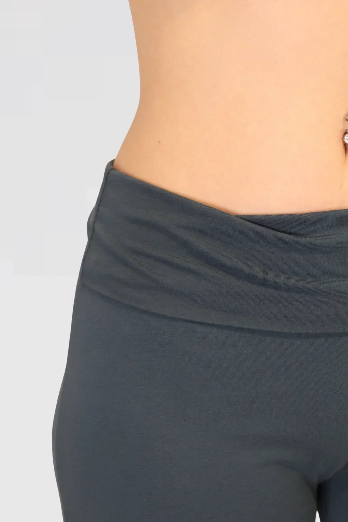 blue yoga leggings worn by a person on a light grey background