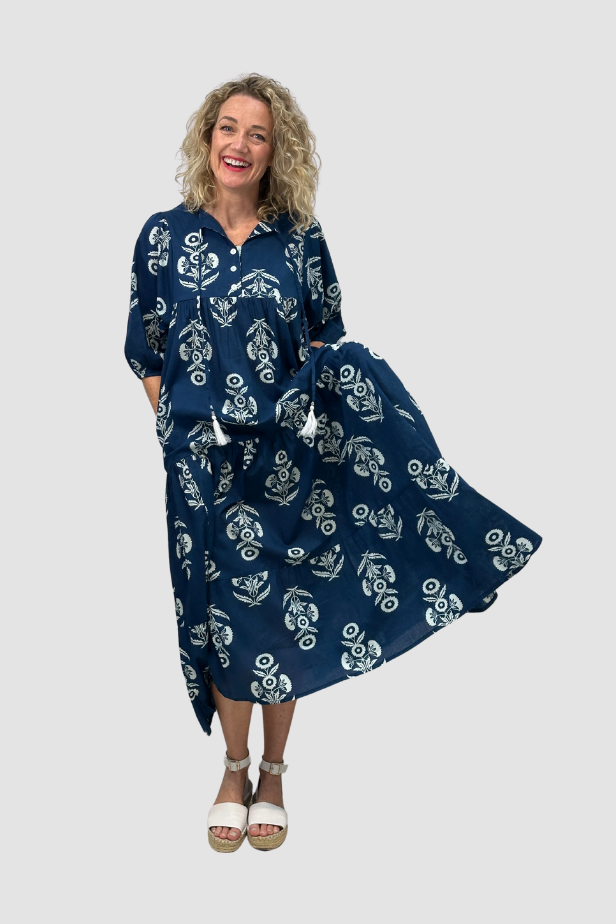 Woman wearing a blue patterned dress on a white background