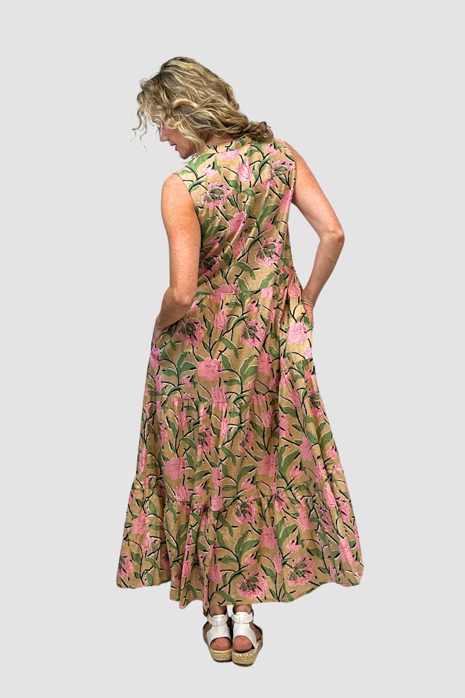 Woman wearing a floral dress on a plain background