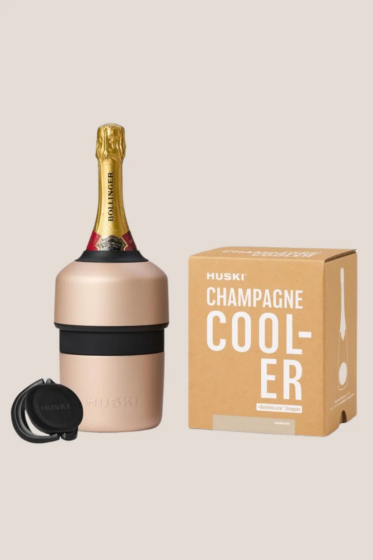 Huski champagne cooler with champagne bottle and packaging on a beige background