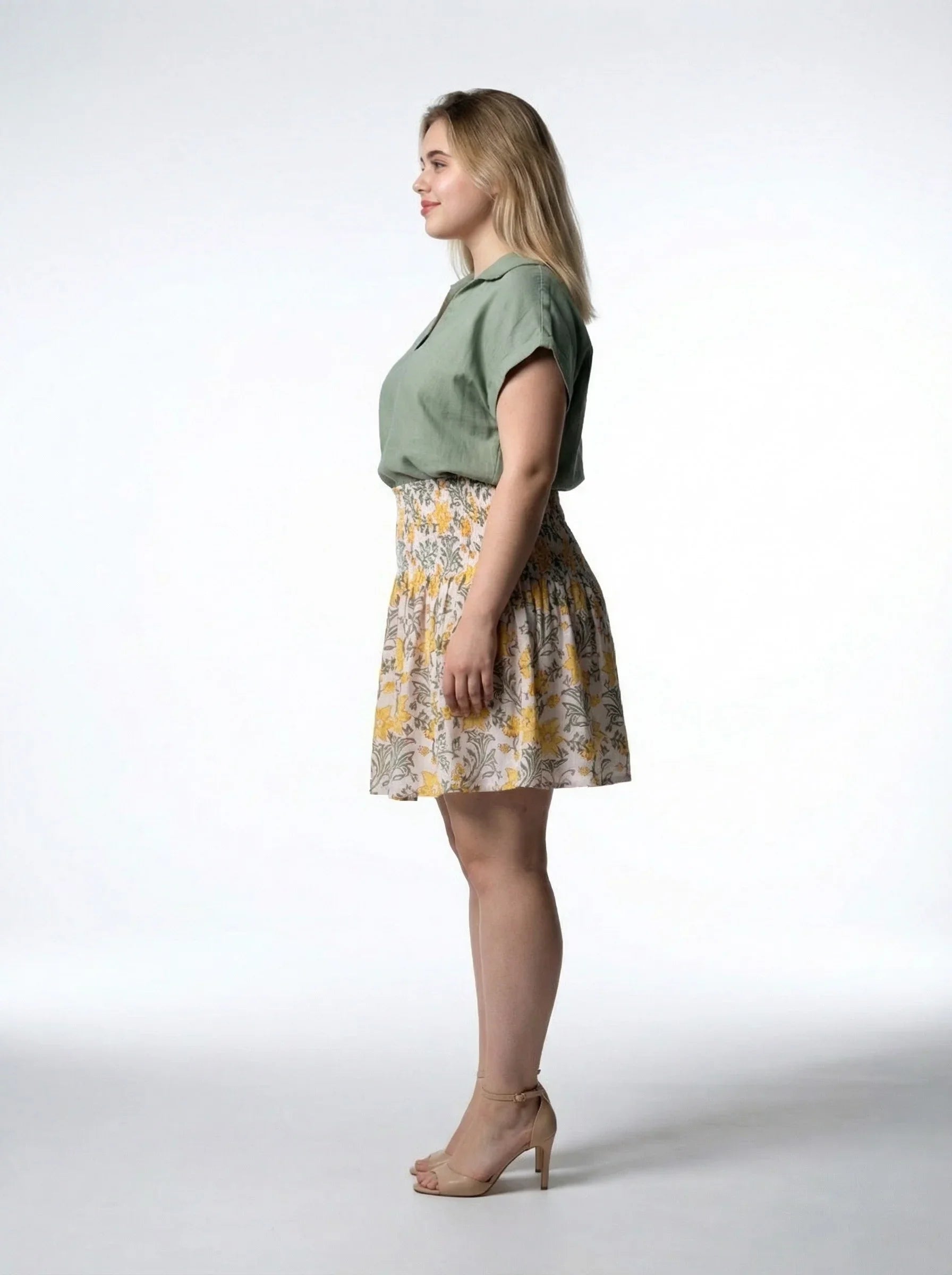 blonde curvy model wearing Honey Petal Mini Skirt with Sage Still Water Top from Reca - side image