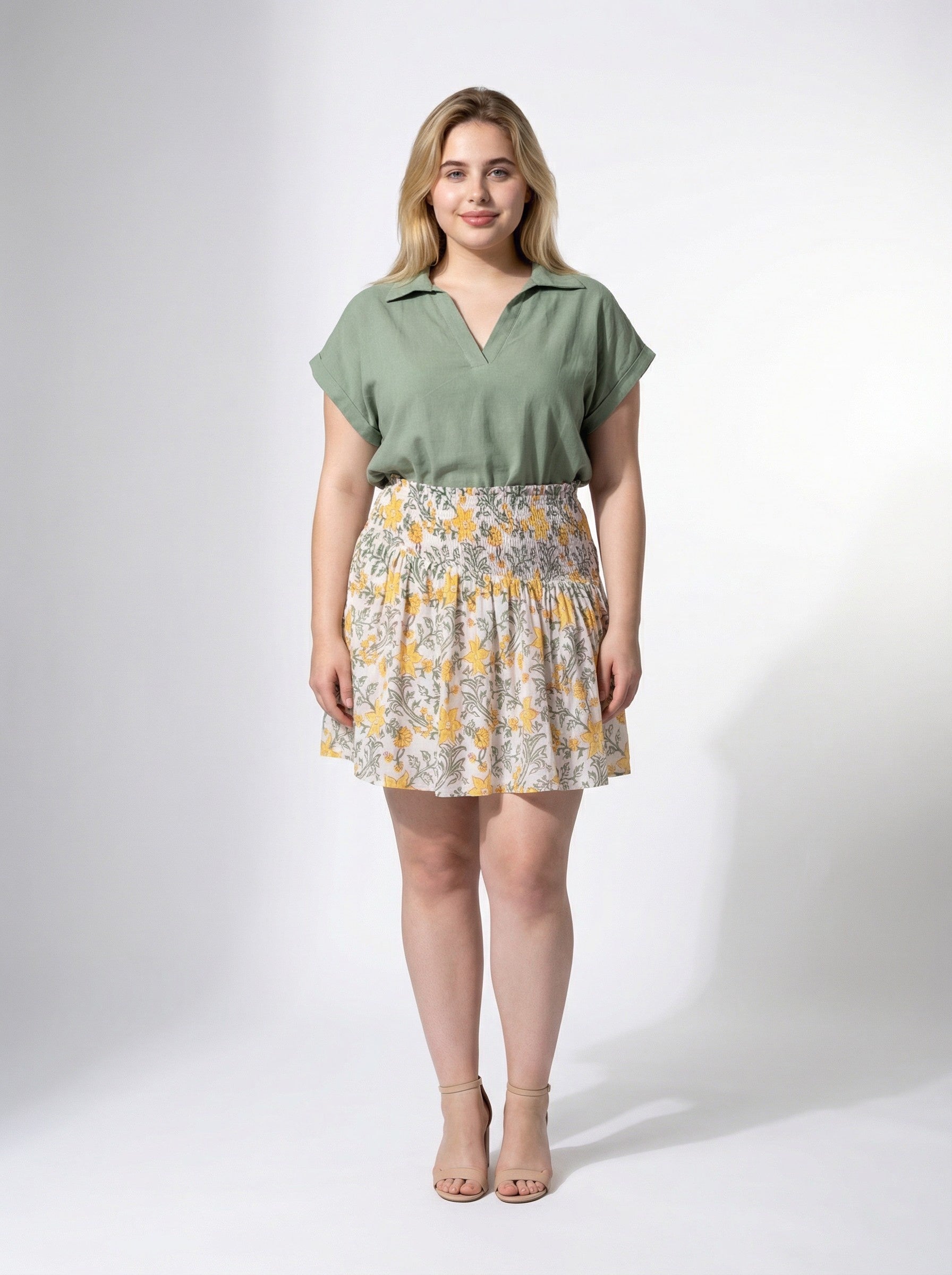 blonde curvy model wearing Honey Petal Mini Skirt with Sage Still Water Top from Reca - front