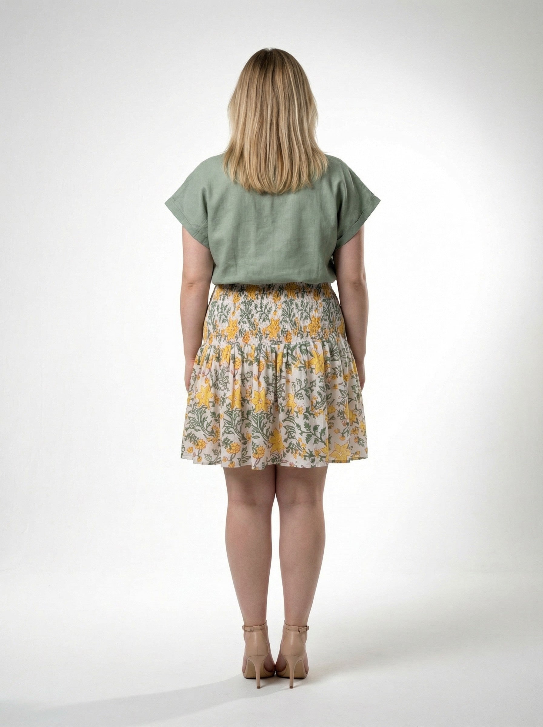 blonde curvy model wearing Honey Petal Mini Skirt with Sage Still Water Top from Reca - Back