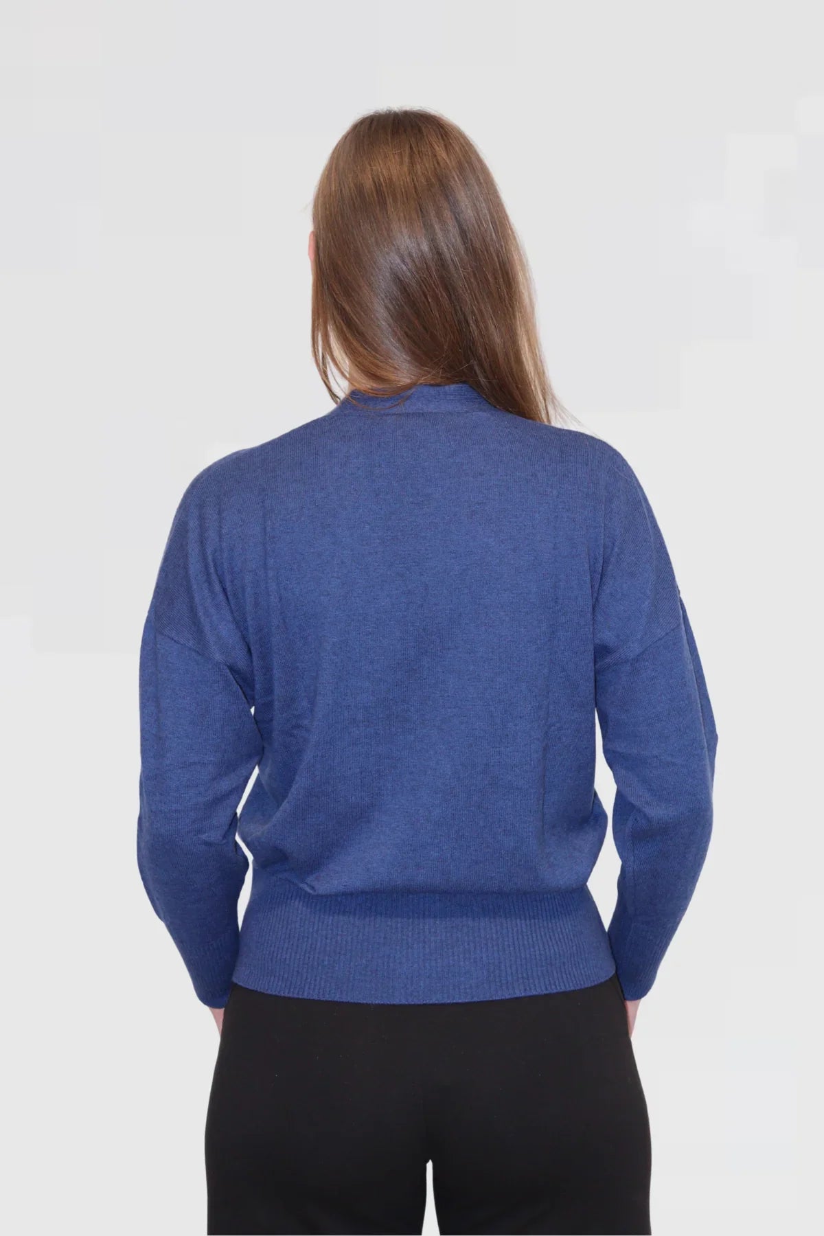 Person wearing a blue sweater on a white background