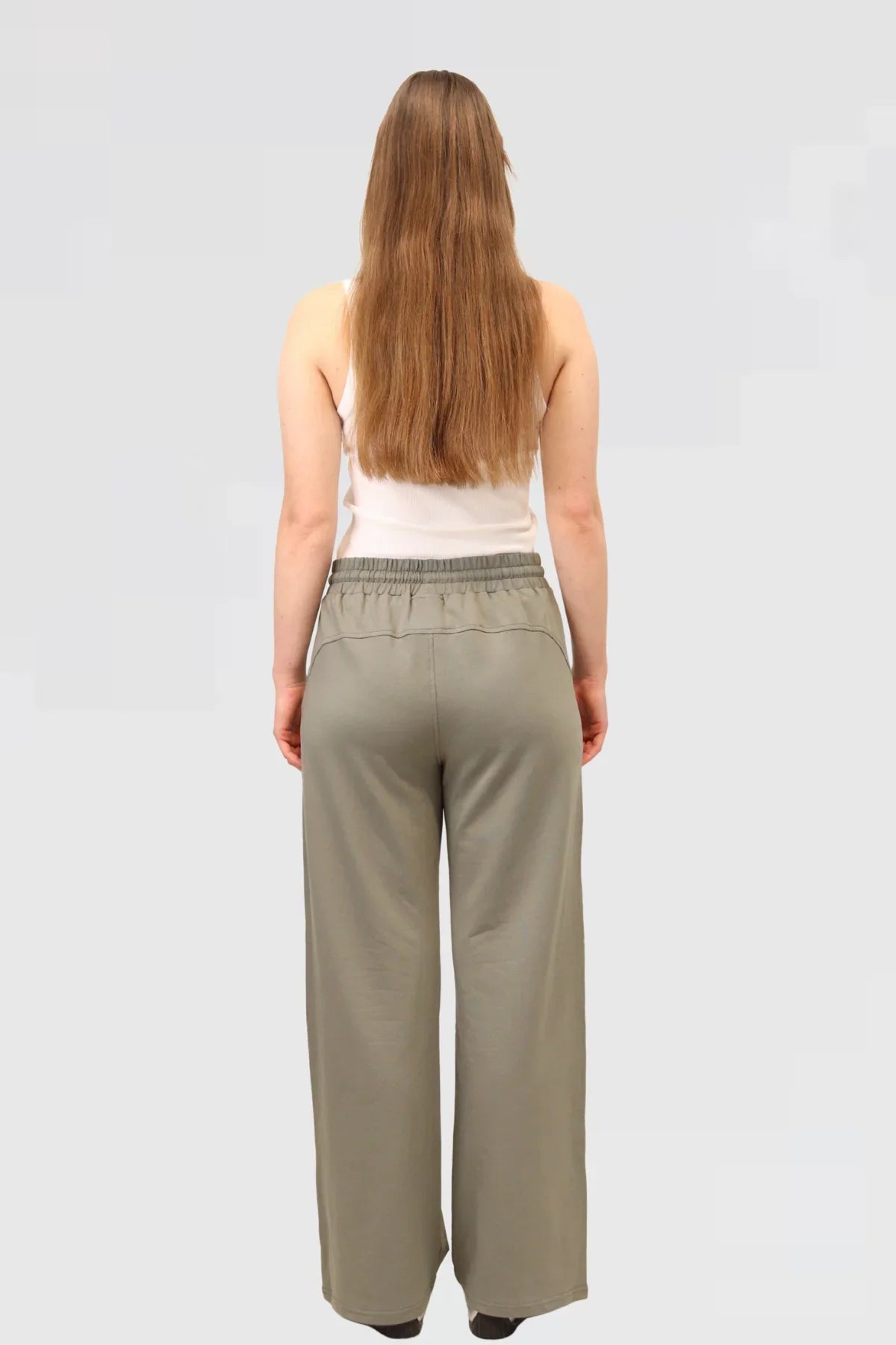 Back view of Agave Drape Trousers in Agave green, relaxed cut with clean lines.