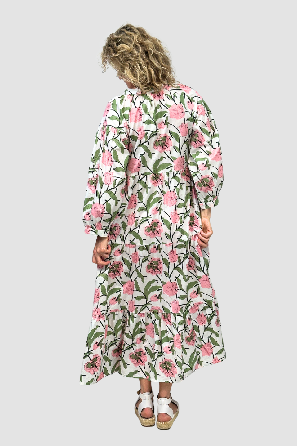 Woman wearing a floral dress on a plain background