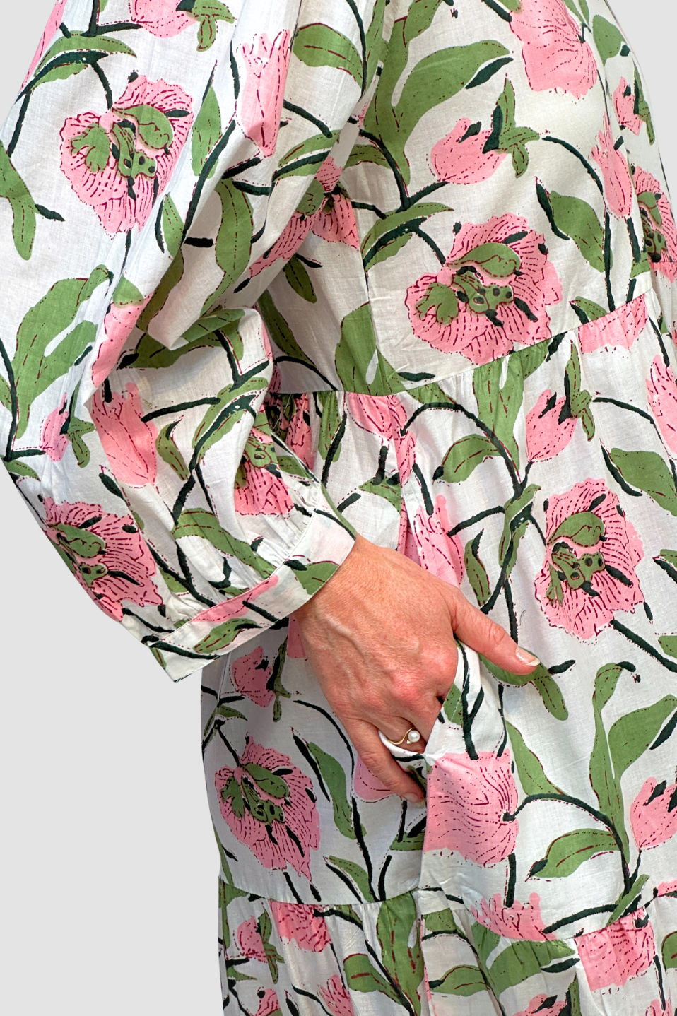 - Blossom Meadow Cotton Midi Dress Floral patterned fabric with pink flowers and green leaves on a white background