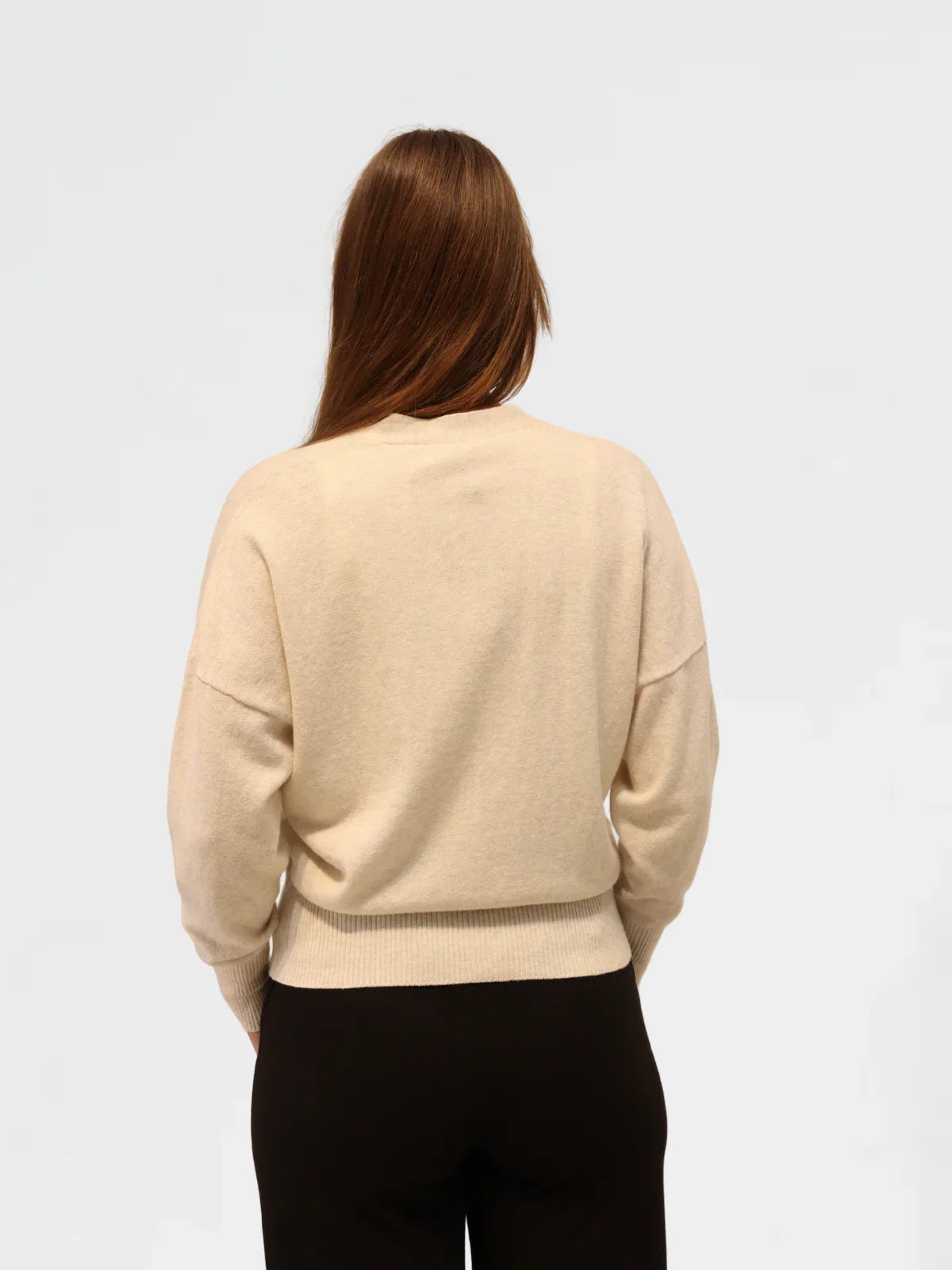 Woman wearing agrey marle cashmere and cotton cardiganr on a white background