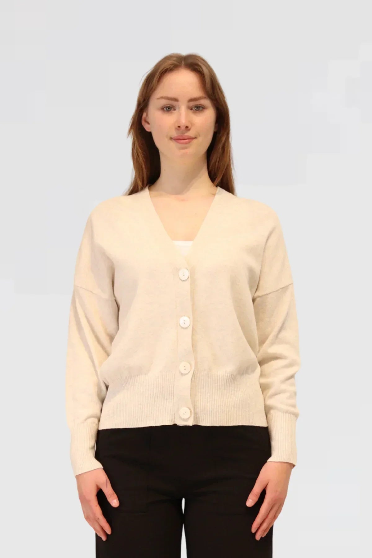 Woman wearing a Cashmere & Cotton Relaxed Cardigan - Grey Marle on a light gray background