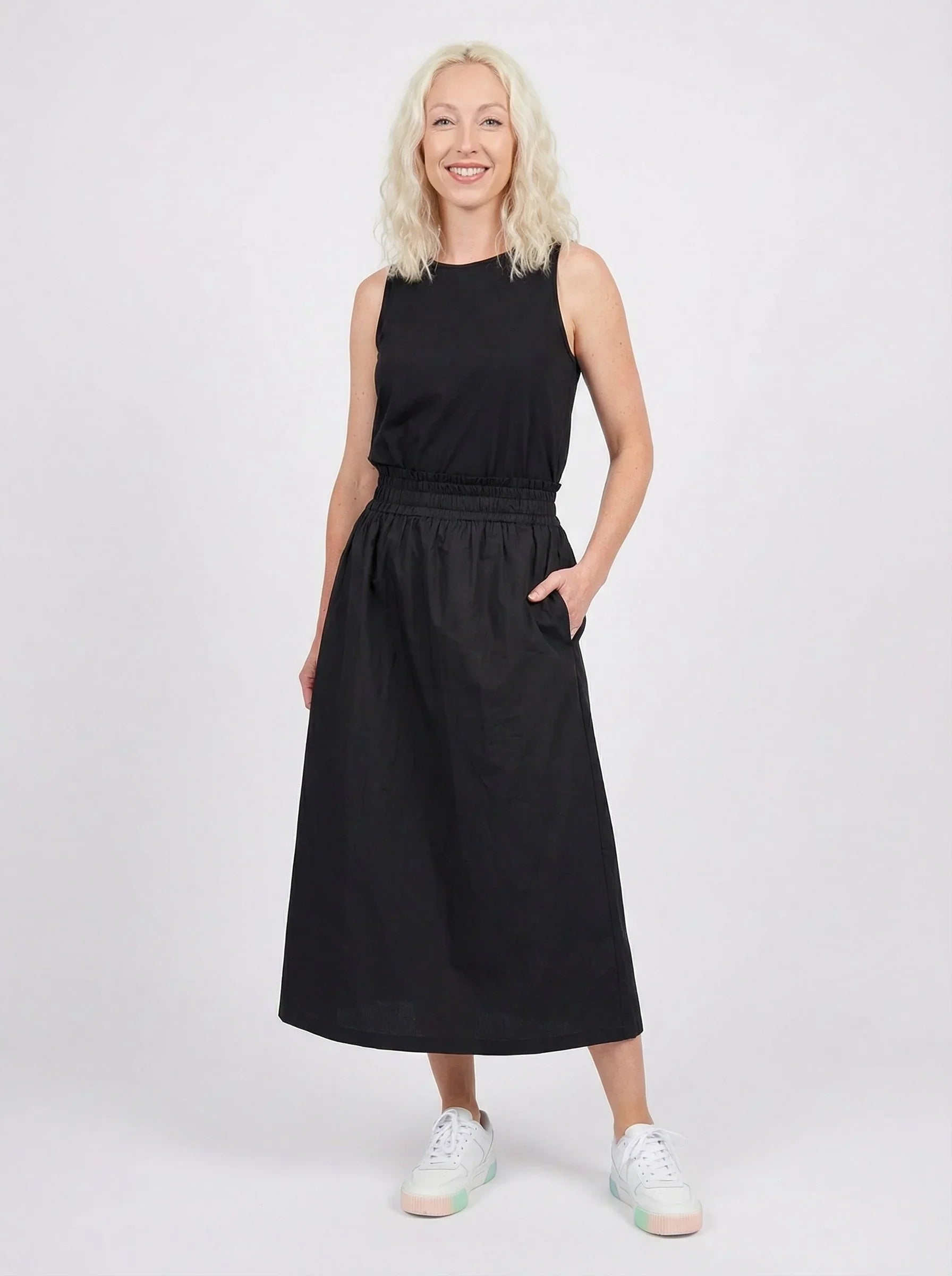 Woman wearing a black sleeveless top with Cotton Maxi Skirt - Black on a white background