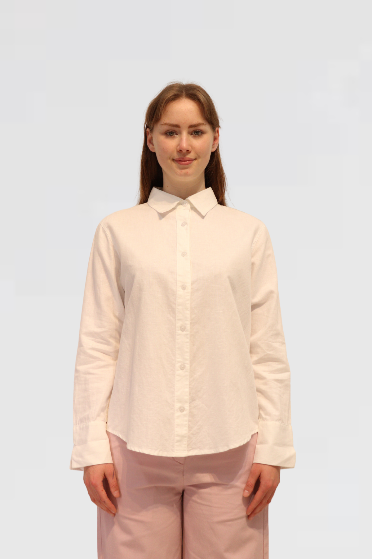 Woman wearing a Linen Shirt - White and dusty pants on a white background