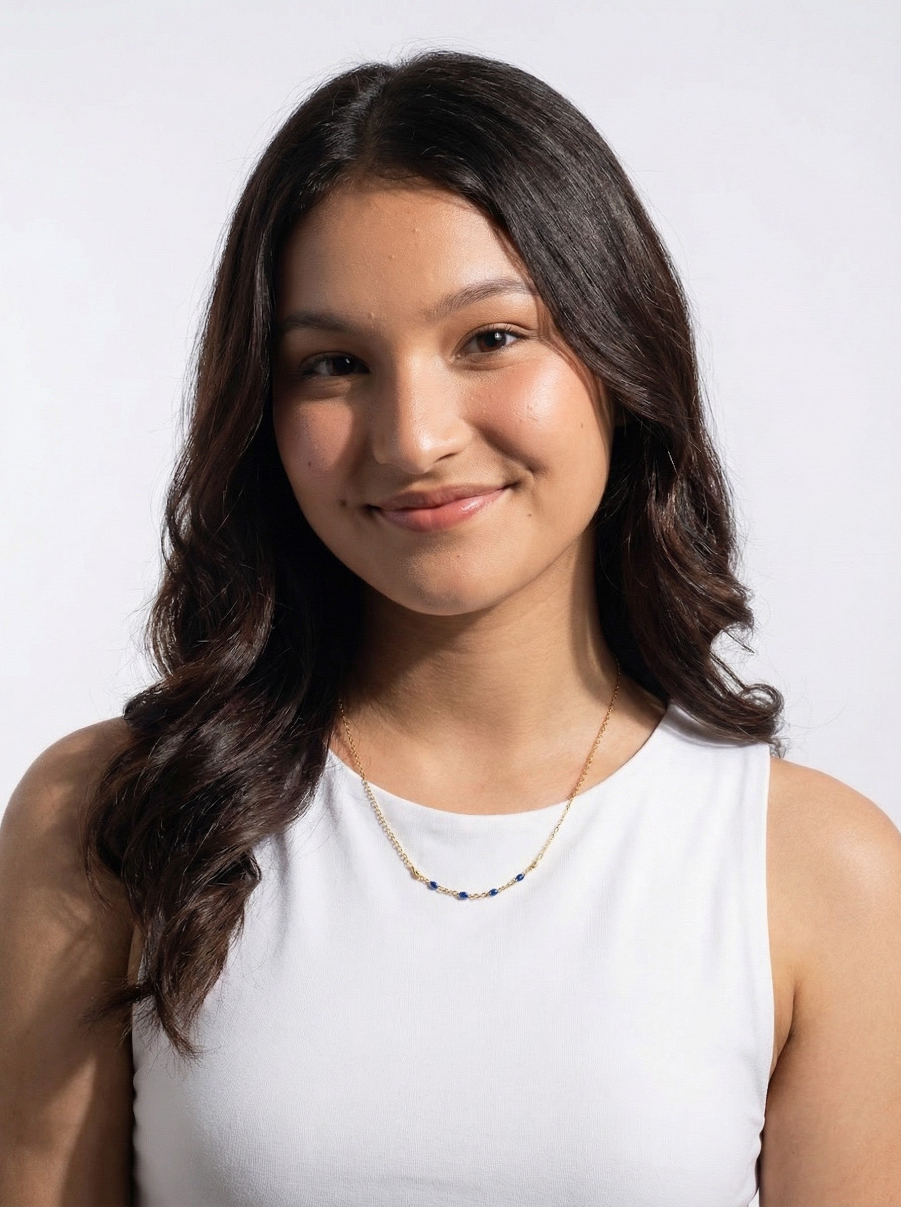 Woman with long dark hair wearing a white top with Midnight Enamel Satellite Necklace against a light background
