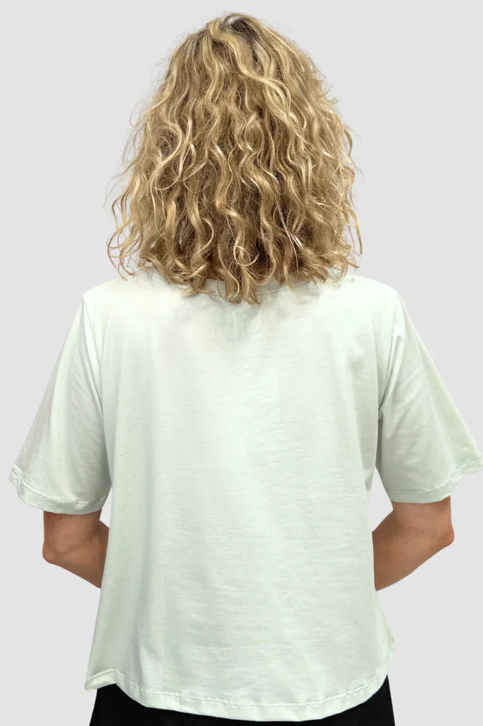 Person wearing a Organic Flex Crew Tee - Pale Turquoise with short sleeves on a plain background