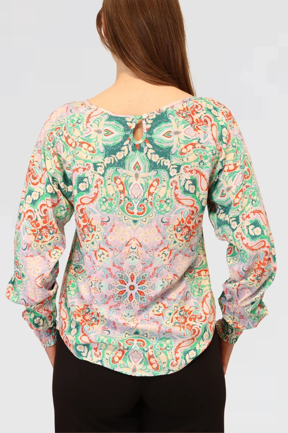 Back view of the Paisley Bloom Blouse in organic cotton, showing its relaxed drape and soft flowing silhouette.