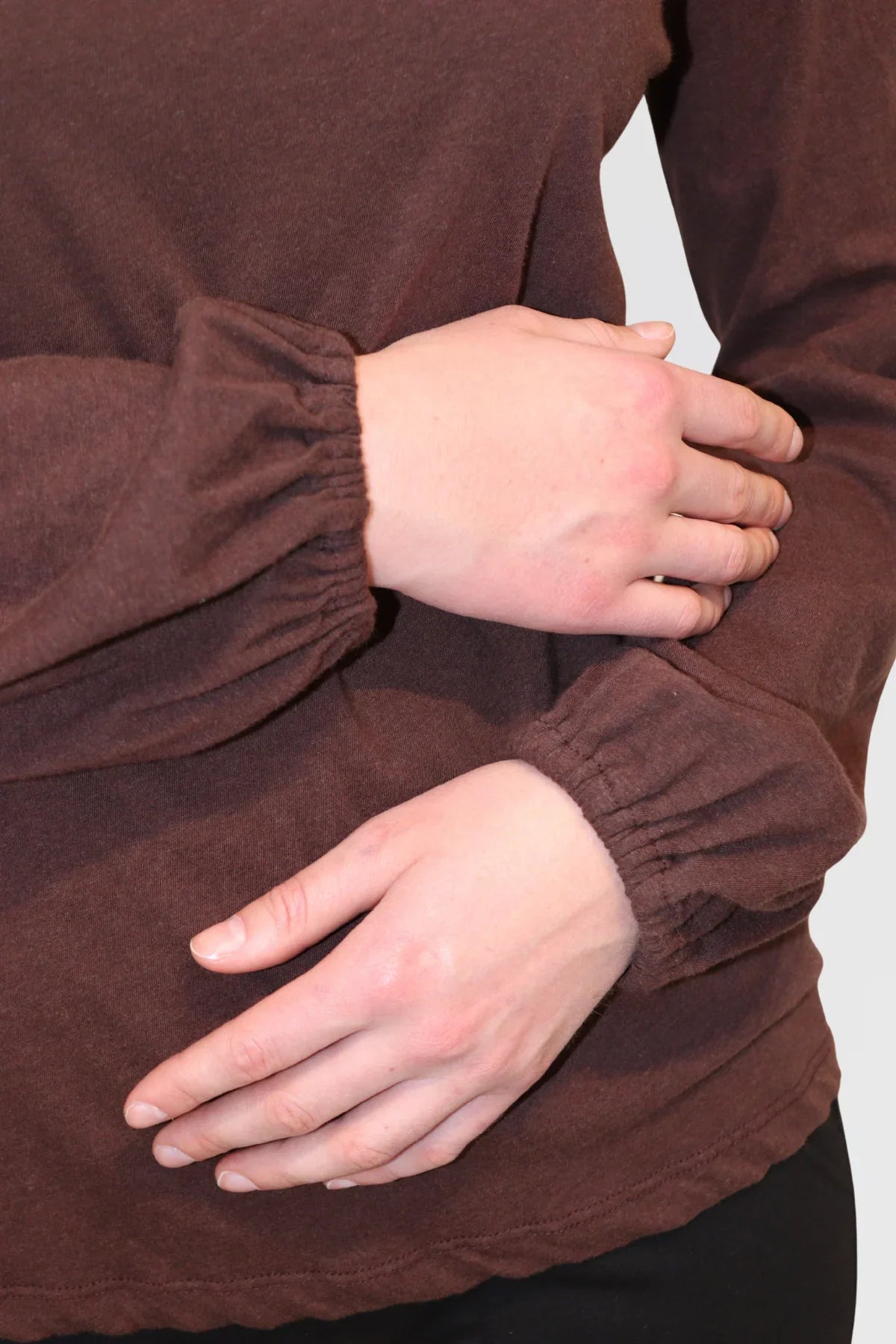 Detail shot of Bishop Blouse in Redwood, showing gathered sleeve cuff and fabric texture.