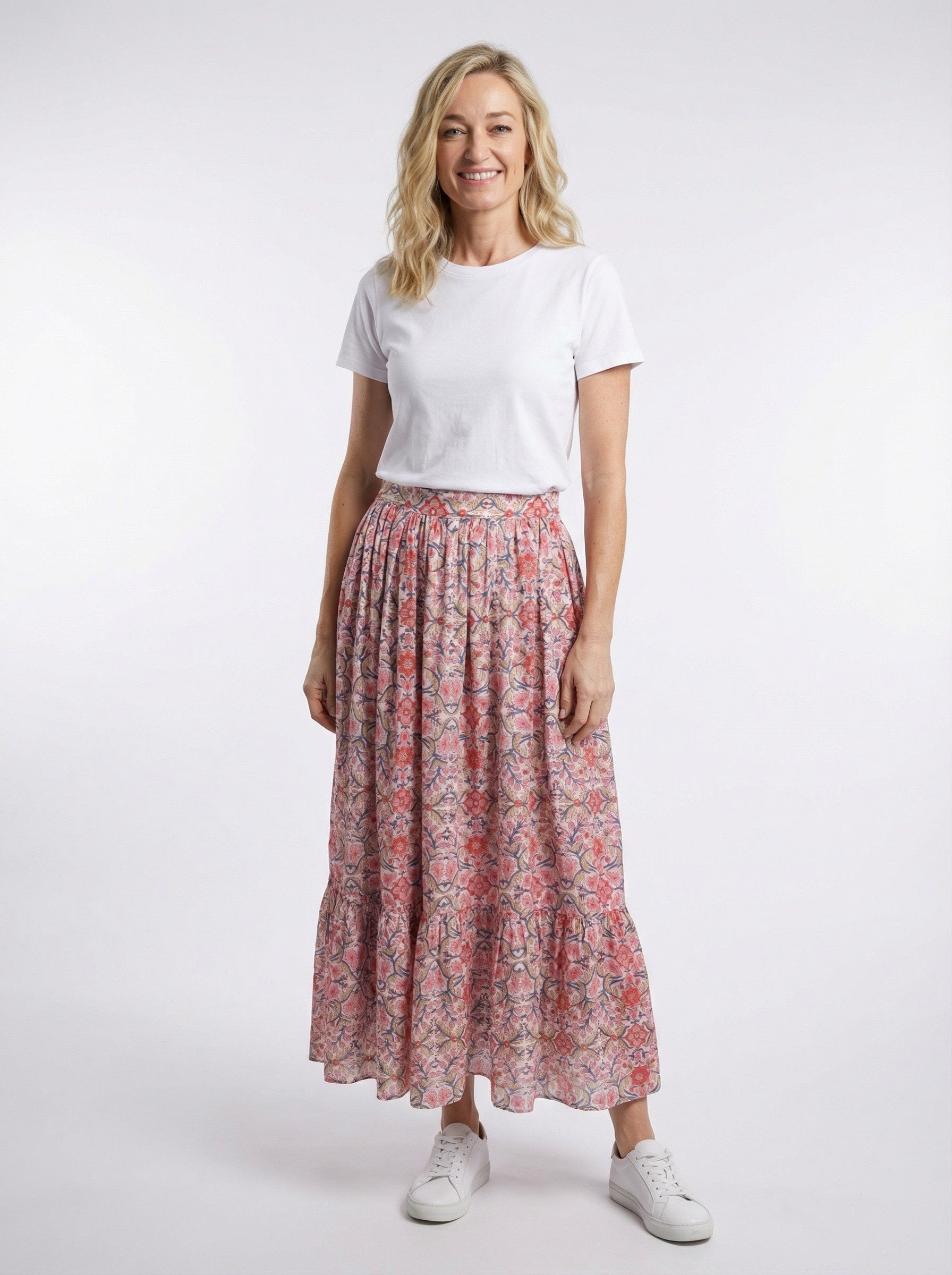 Woman wearing a white t-shirt and Rosette Garden Maxi Skirt on a white background