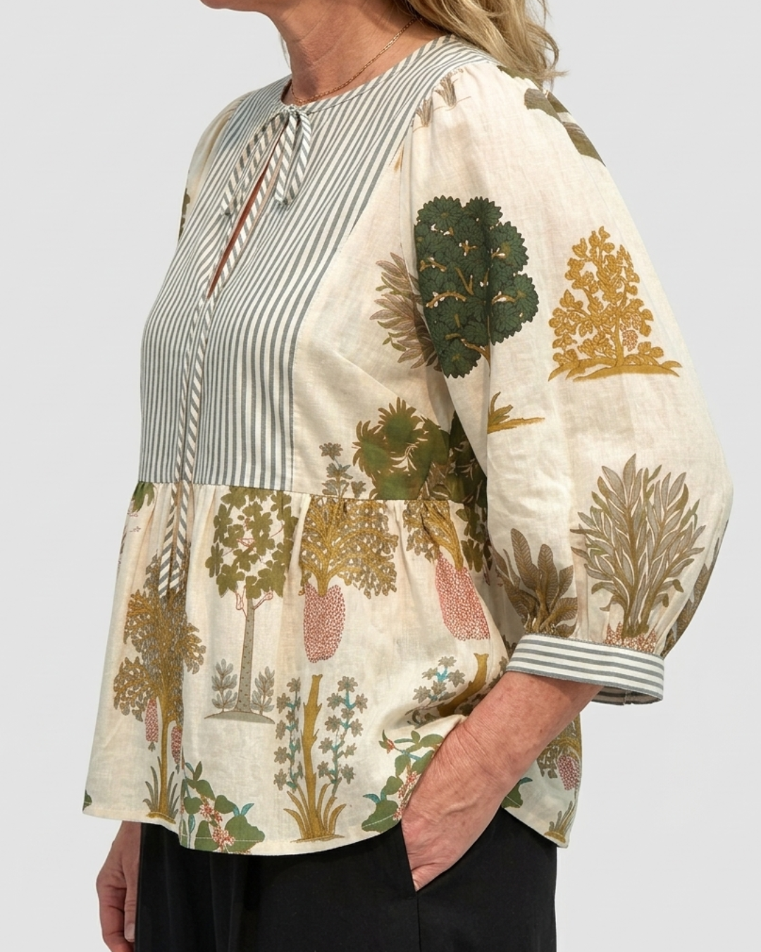 Side view of the Botanica Luxe Cotton Blouse showing the olive and ochre botanical tree print on the three-quarter blouson sleeve