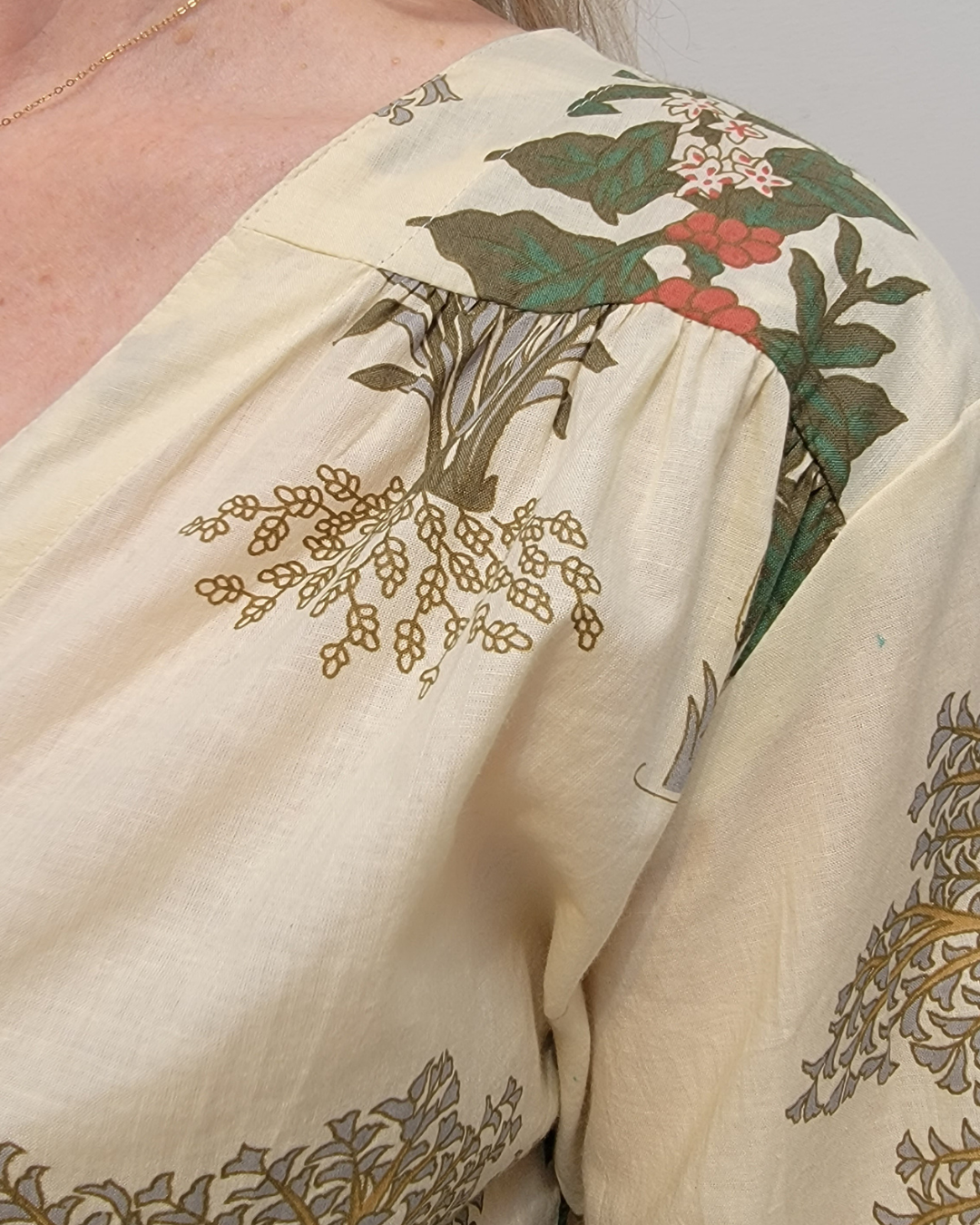 Palm Garden Cotton Blouse in 100% cotton with an earthy green, rust and golden botanical print on a soft ivory background