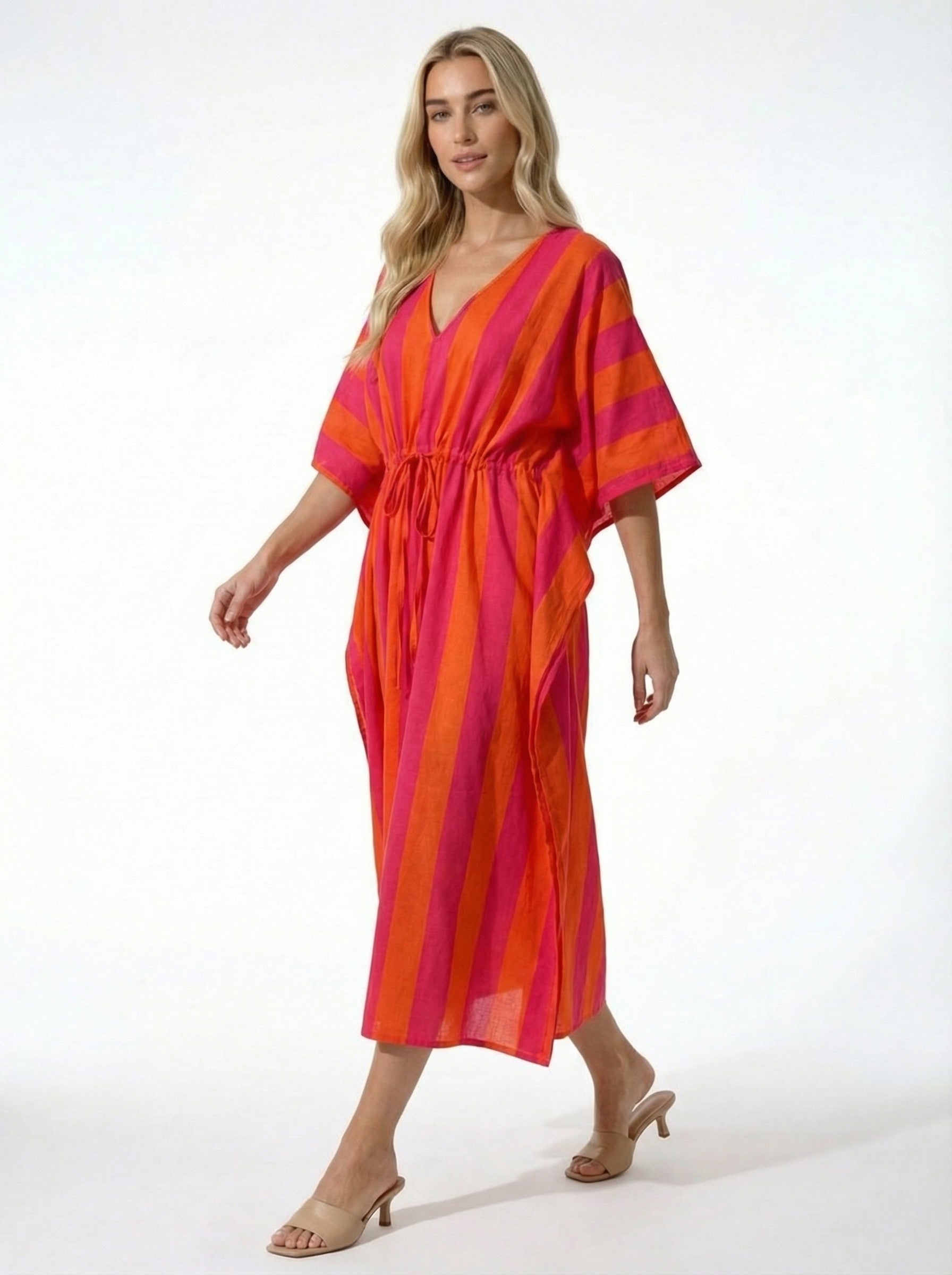 Woman wearing a vibrant Sunset Stripe Pink & Orange Kaftan on a white background