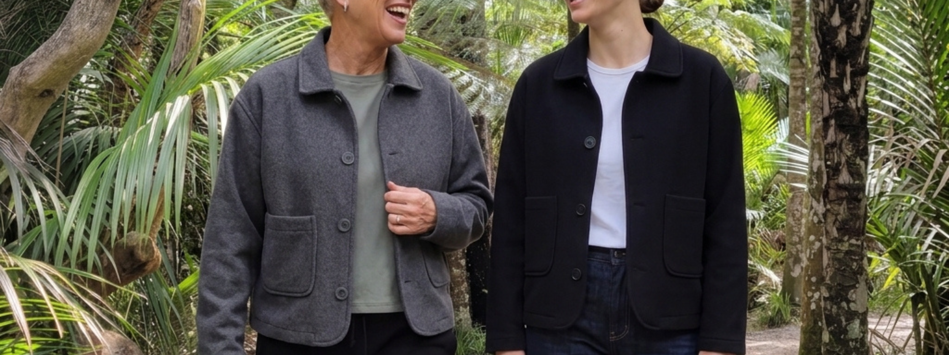 Two people standing outdoors in a natural setting, wearing The Wool Edit Jackets from Reca.