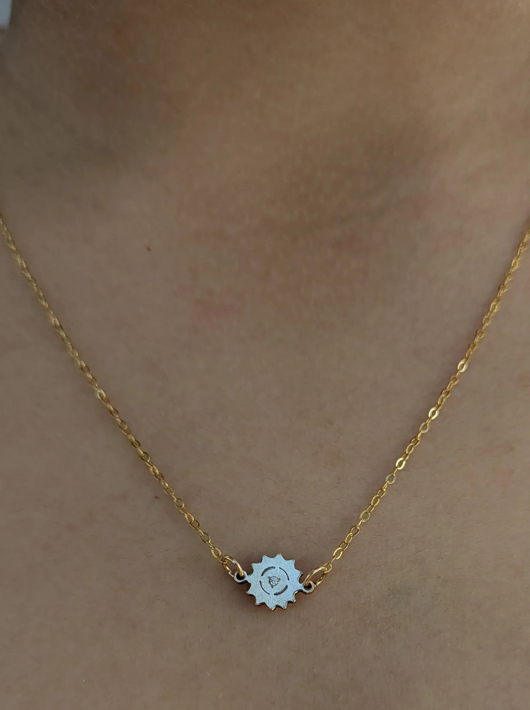 Ethical gold chain necklace with sun-shaped pendant on model, Reca jewelry