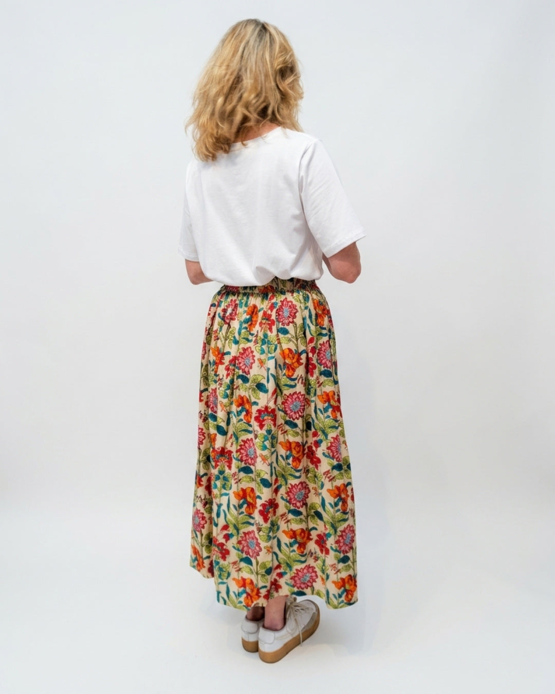 Back view of the Reca Bloomfield Garden Skirt showing the gathered elasticated waistband and full flowing midi hem in a multicolour garden print