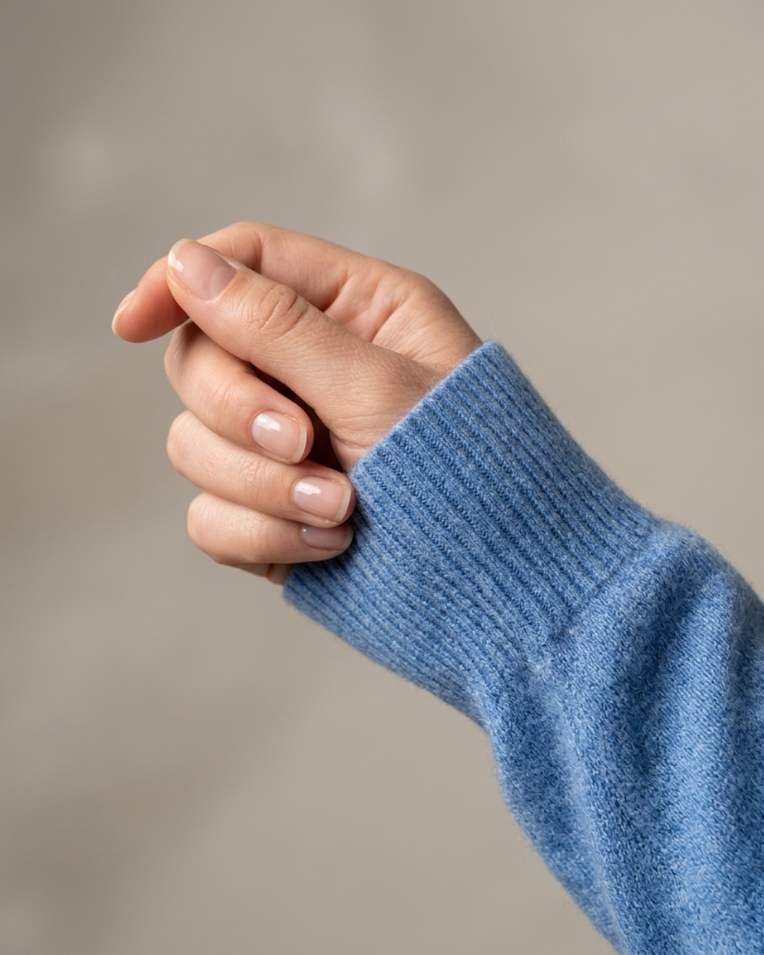 Close-up of the ribbed cuff on the denim blue Cashmere-Merino cardigan sleeve