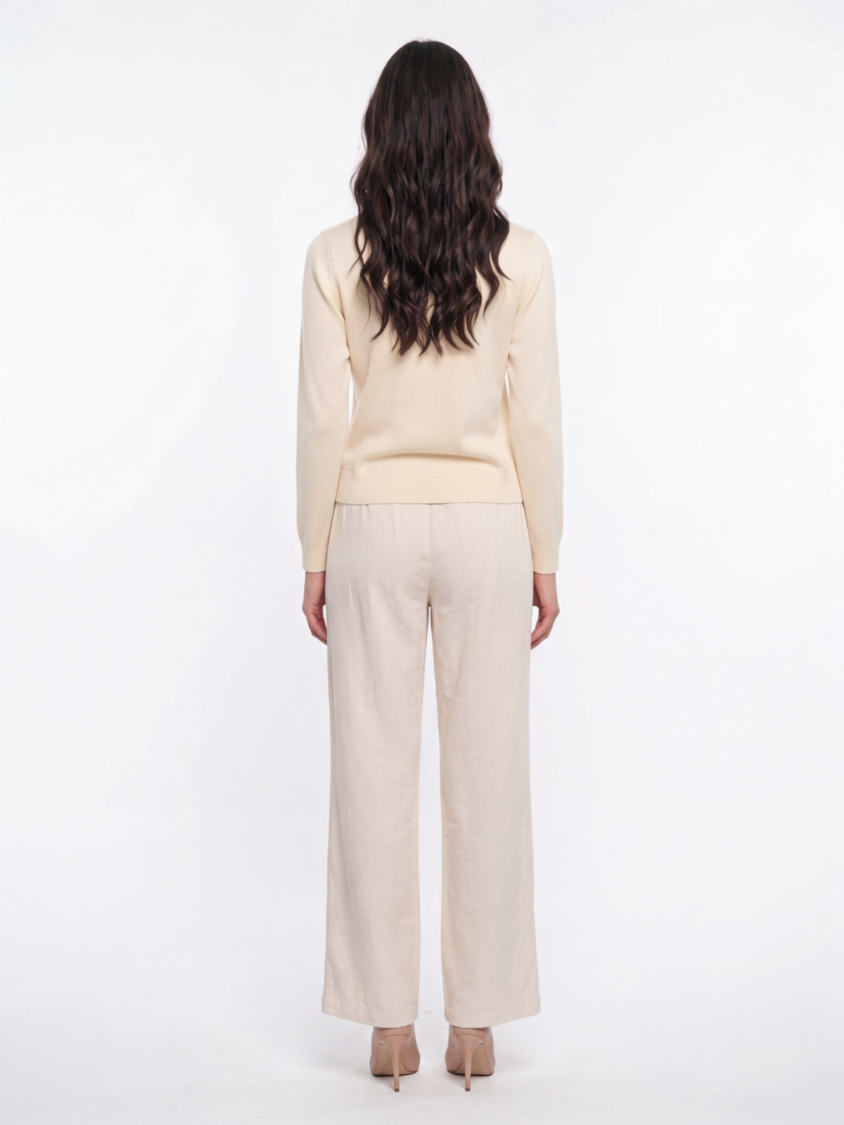 Back view of woman wearing a natural cream Cashmere-Merino Cardigan with matching trousers