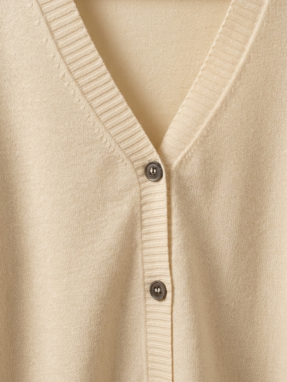 Close-up of natural cream Cashmere-Merino Cardigan V-neckline and dark buttons