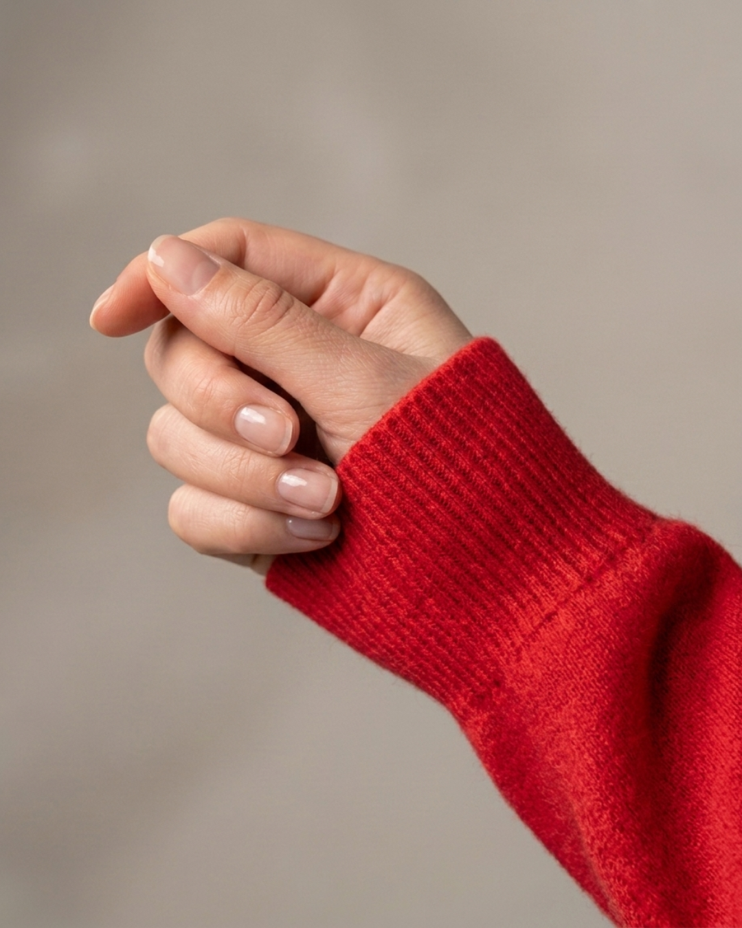 Close-up of the ribbed cuff on the red Cashmere-Merino cardigan sleeve