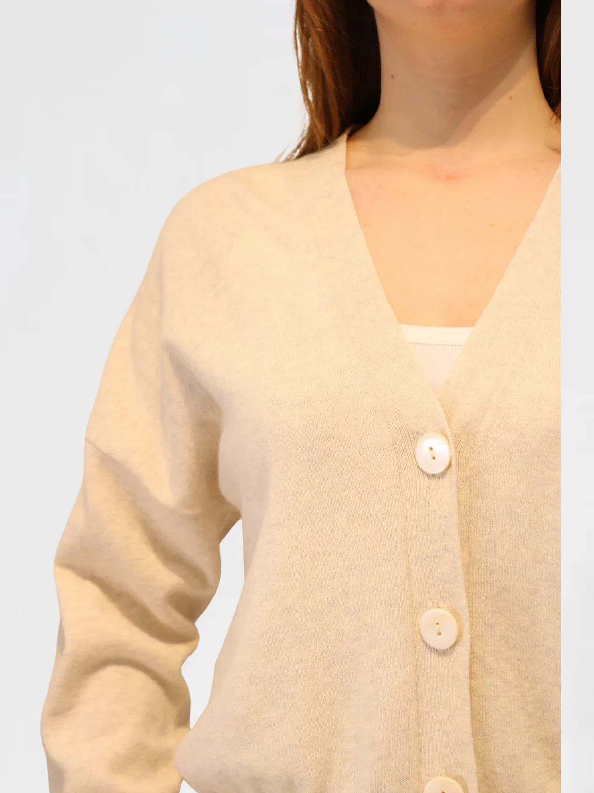 grey marle cashmere and cotton cardigan worn by a person on a light gray background