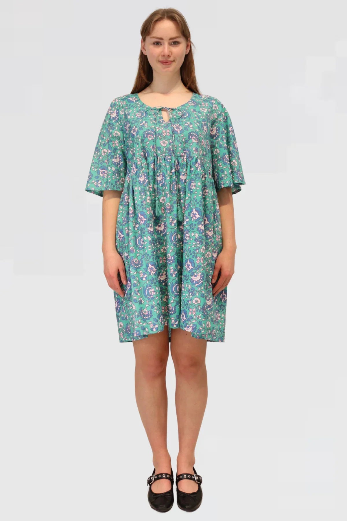 Front view of Petal Tapestry Tiered Dress with scoop neckline and tie detail, short wide sleeves, and floral tapestry print.