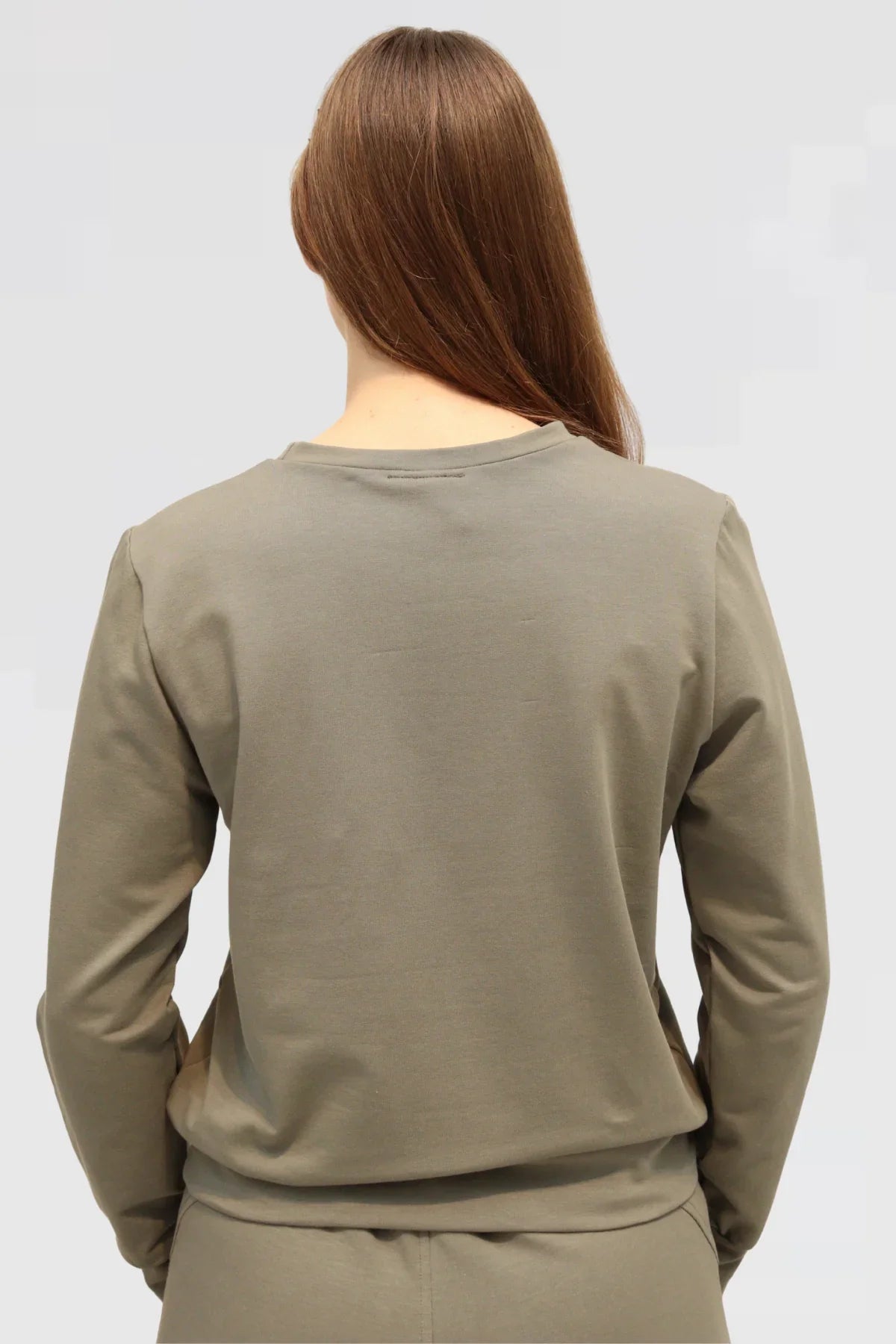 Back view of Reca Agave Drape Trousers styled with matching Organic Cotton Sweater, relaxed fit silhouette.