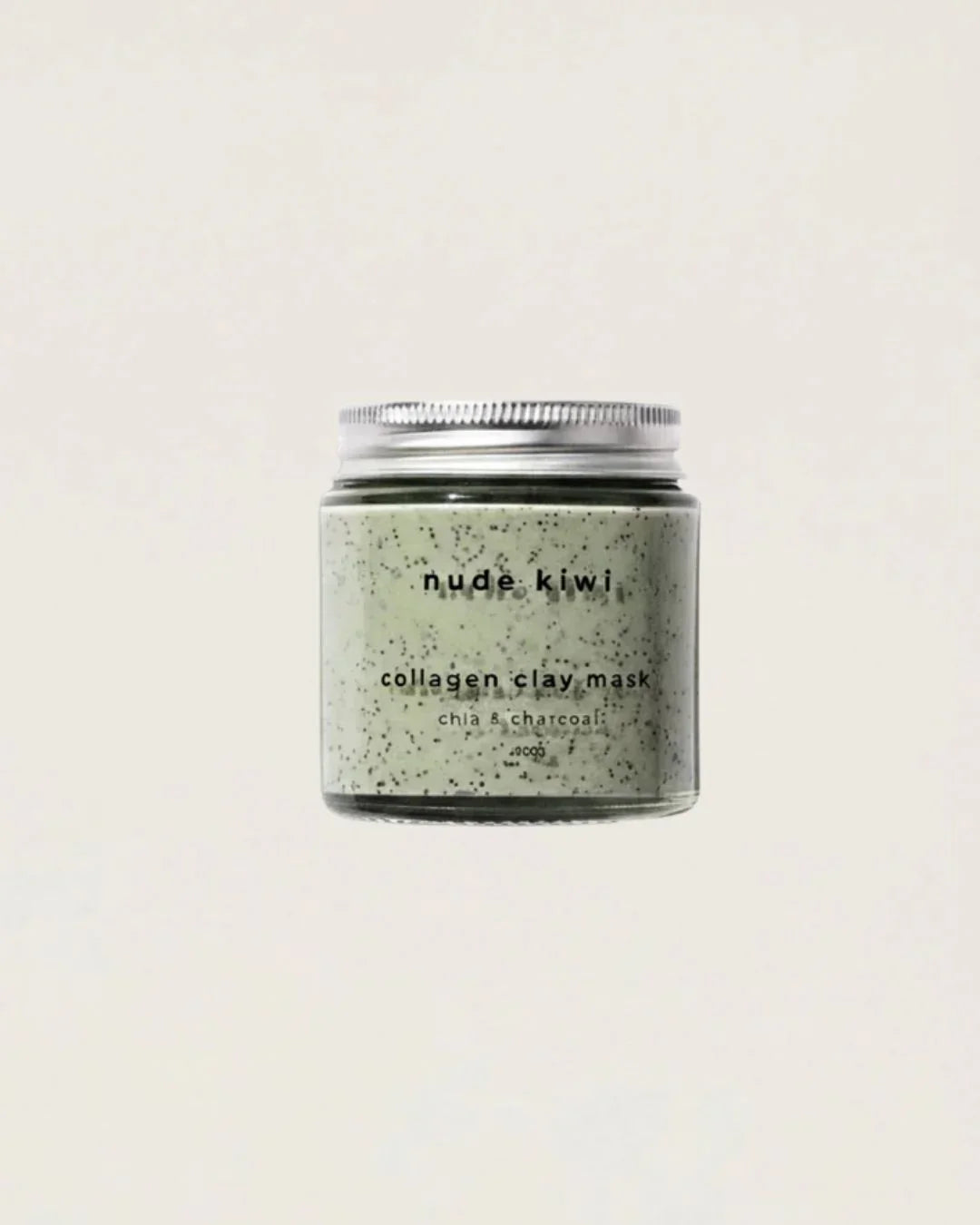 Nude Kiwi Collagen Clay Mask jar with chia and charcoal, speckled green texture on a beige background