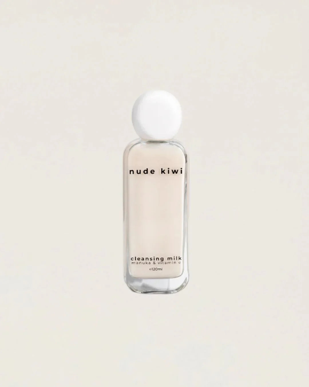 Nude Kiwi Cleansing Milk bottle with manuka and vitamin E on a beige background