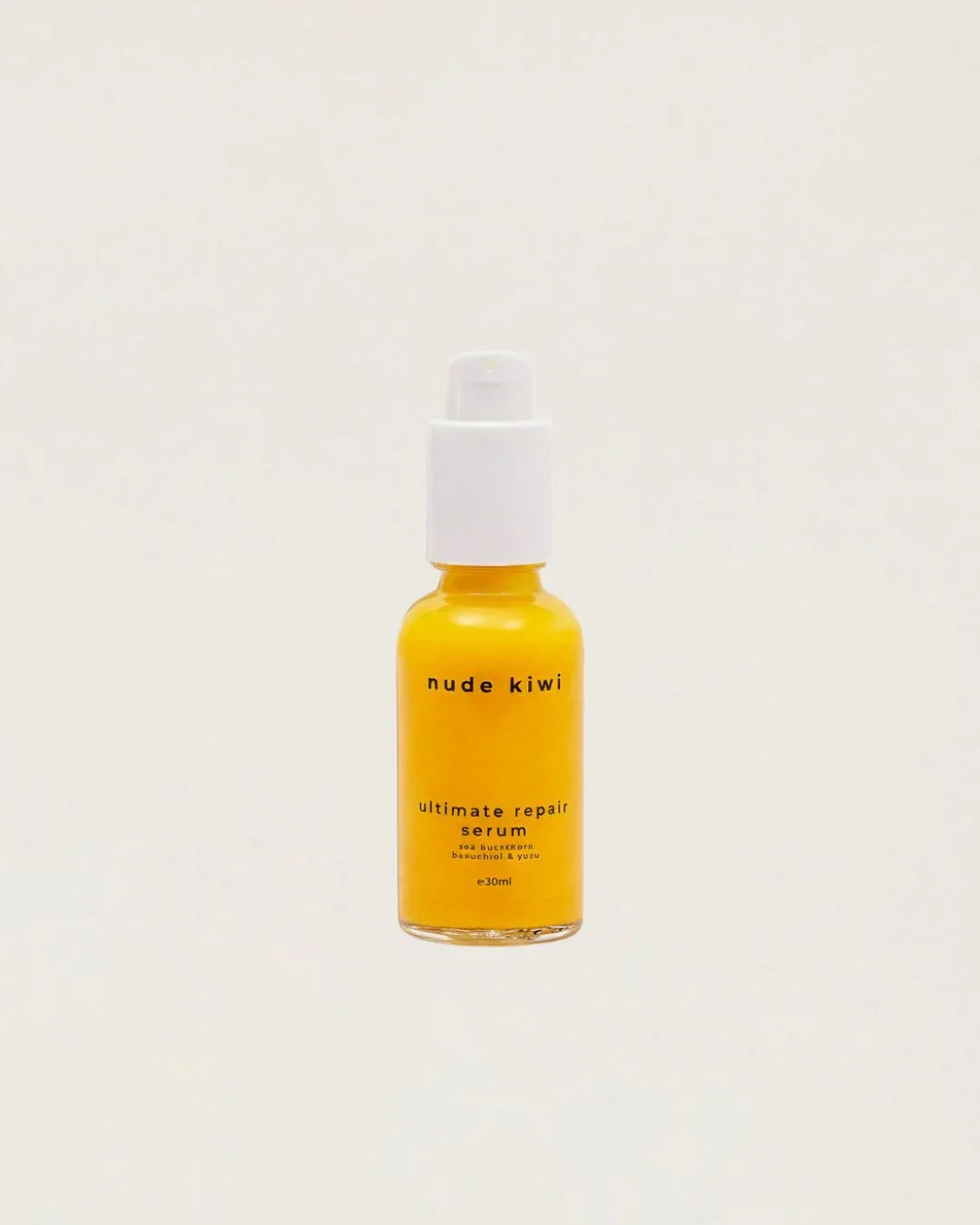 Nude Kiwi Ultimate Repair Serum bottle with bakuchiol and sea buckthorn oil on a beige background
