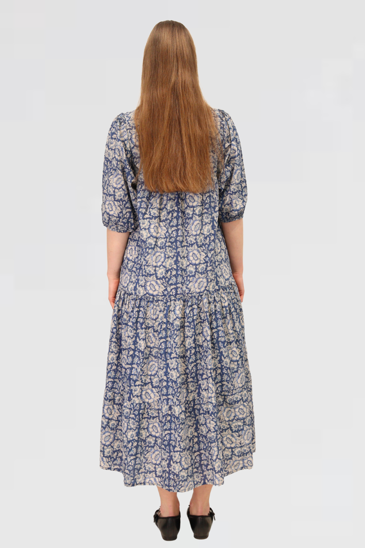 Back view of Serene Petals Maxi Dress with relaxed fit, tiered skirt, and all-over blue floral print.