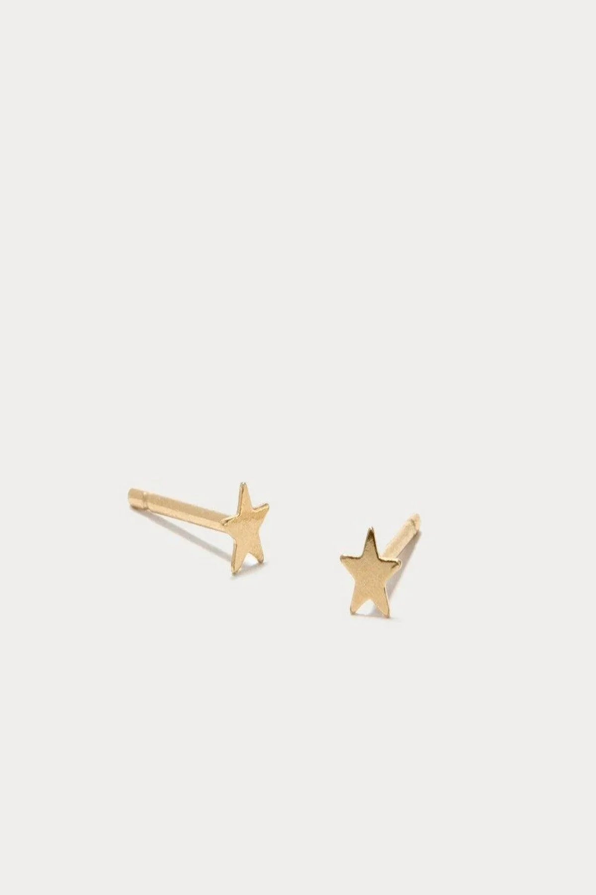 Close-up of an ear with a gold star-shaped earring