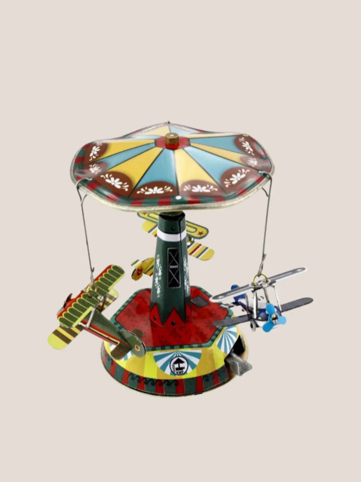 Colorful toy carousel with airplanes on a beige background