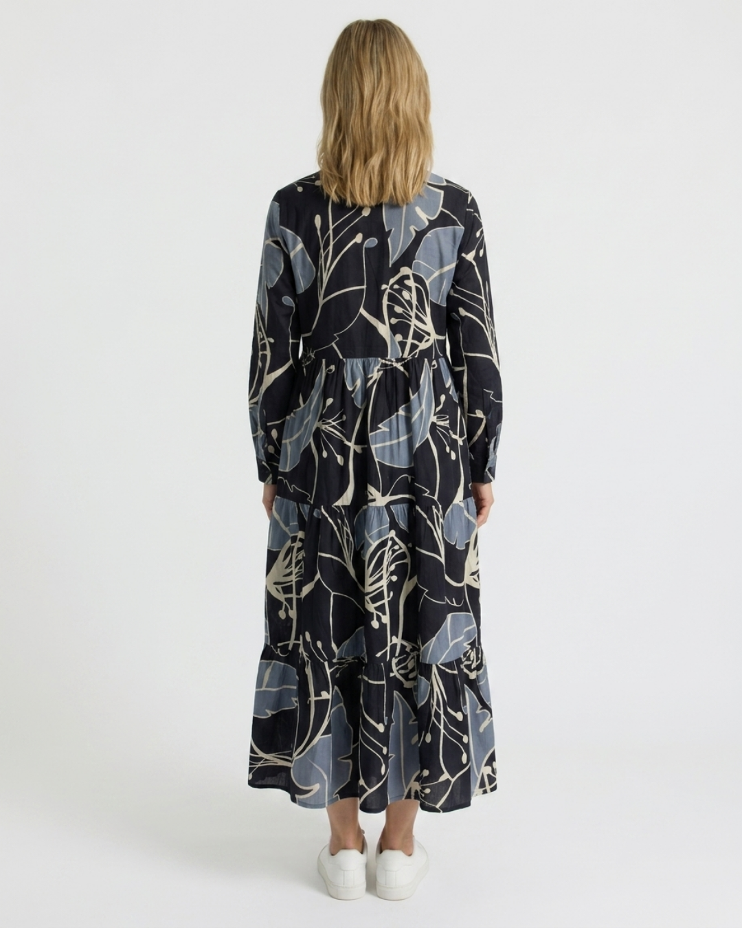 Back view of the Reca Indigo Bloom navy cotton midi dress with long sleeves and tiered skirt