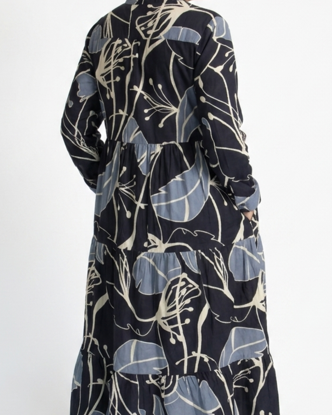 Side detail of the Reca Indigo Bloom navy cotton midi dress with a hand in the deep side-seam pocket