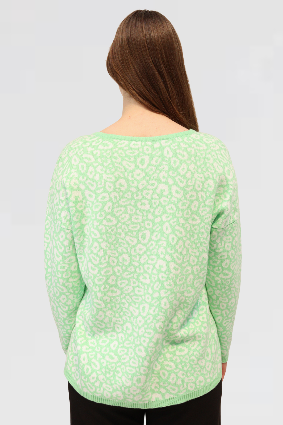 model is showcasing the back of Cotton Jacquard Sweater - Apple