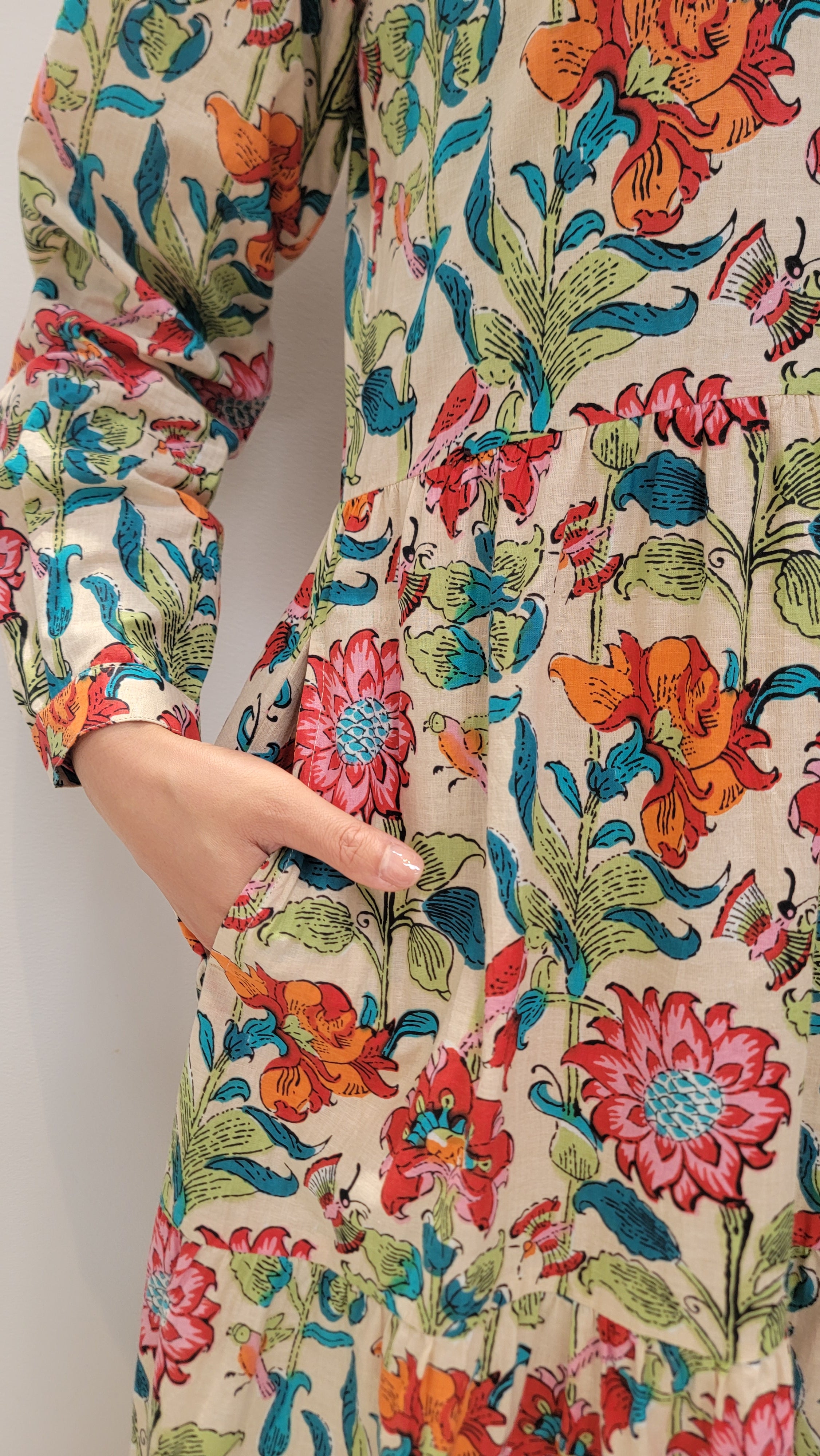 model is show casing the pocket of the Bloomfield Garden Dress 