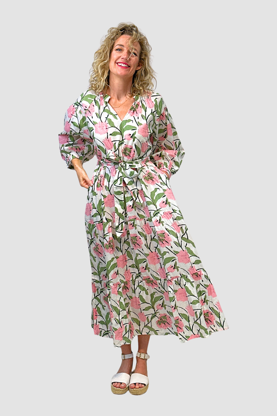 Woman wearing a Blossom Meadow Cotton Midi Dress, floral on a white background
