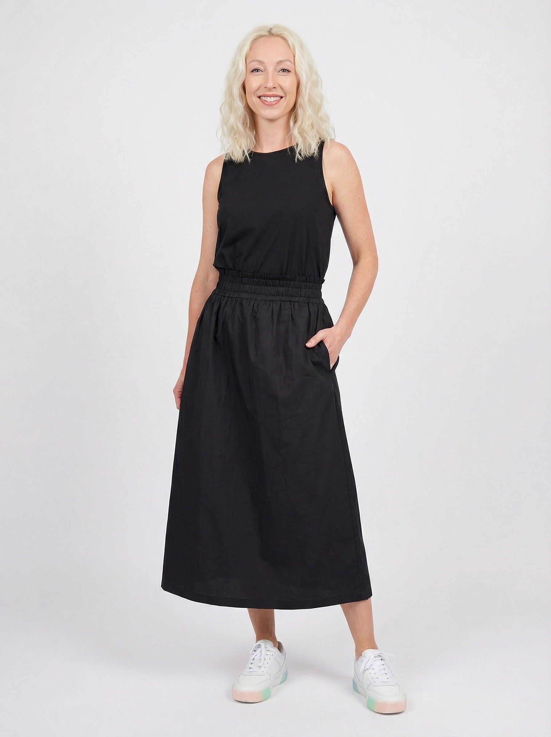 Woman wearing a black sleeveless  top with Cotton Maxi Skirt - Black on a white background