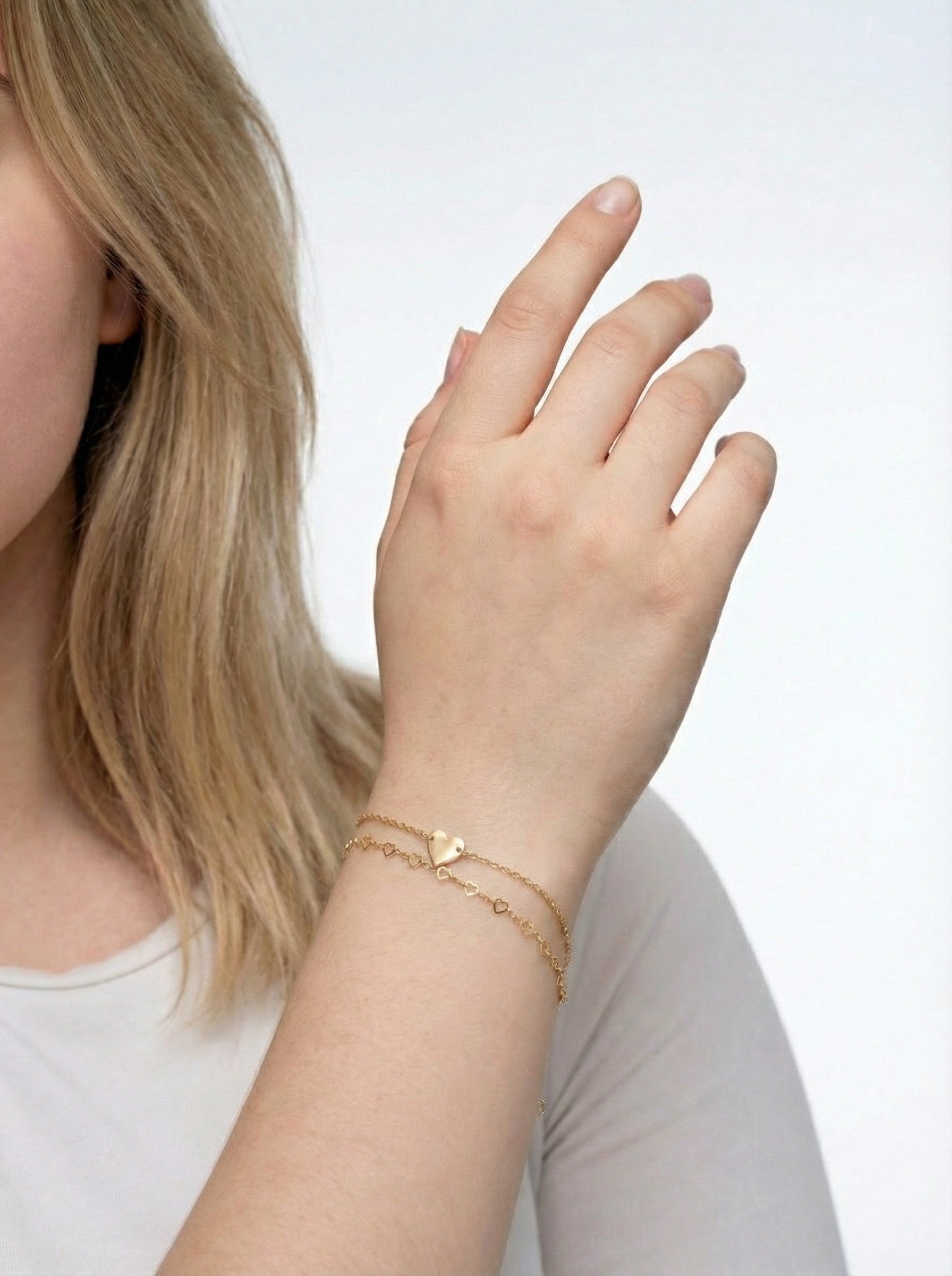 model is wearing Gold Heart Bracelet