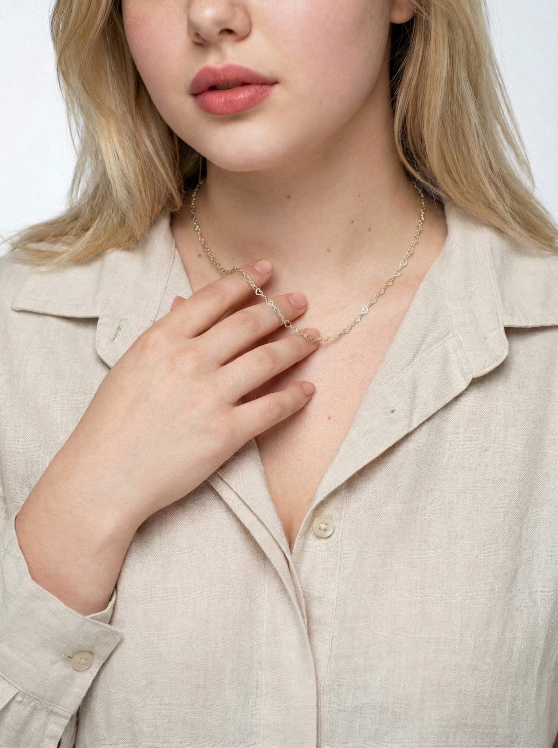 Model is wearing a Gold Heart Link Chain necklace.