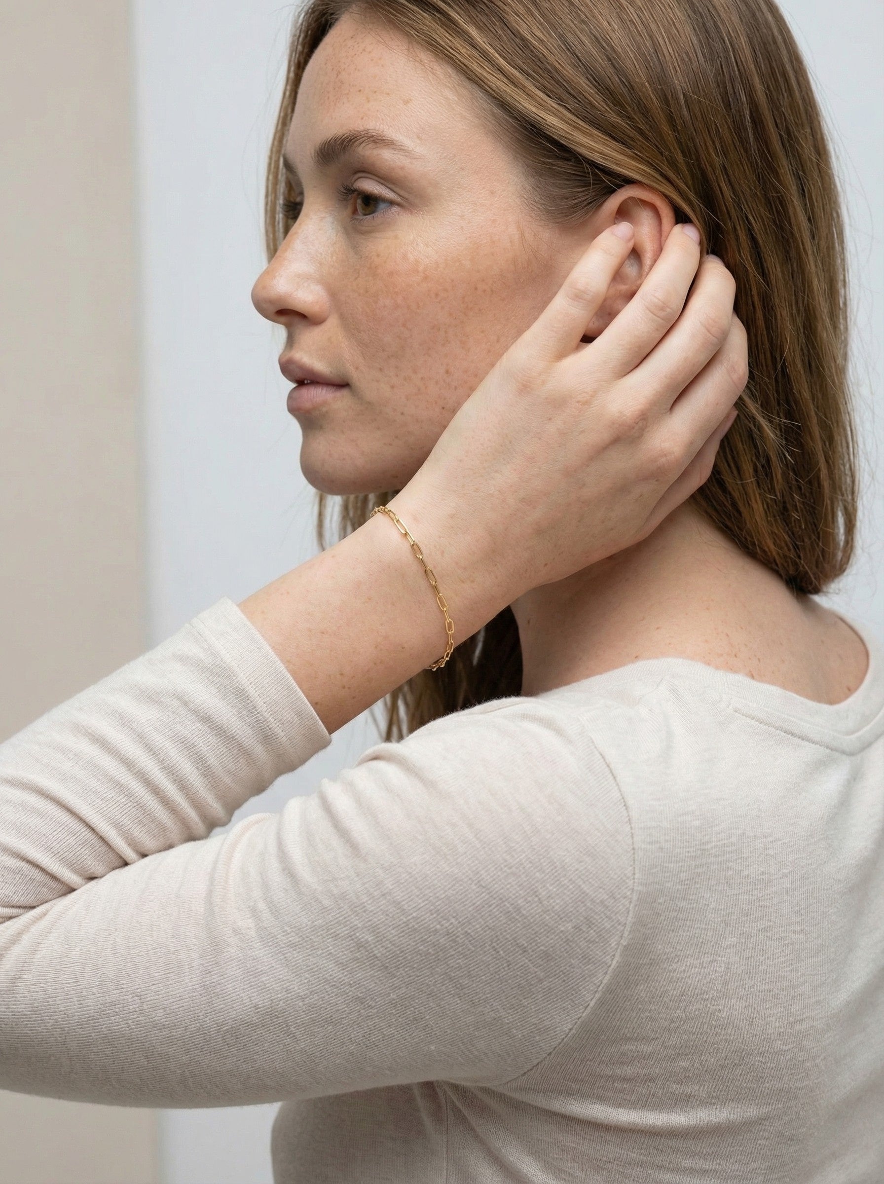 Gold Paper Clip Bracelet on a brunette model