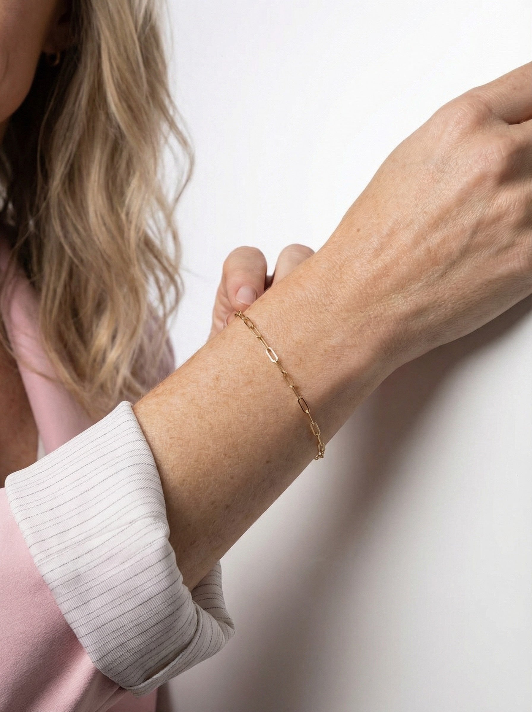 model is modelling Gold Paper Clip Bracelet close up