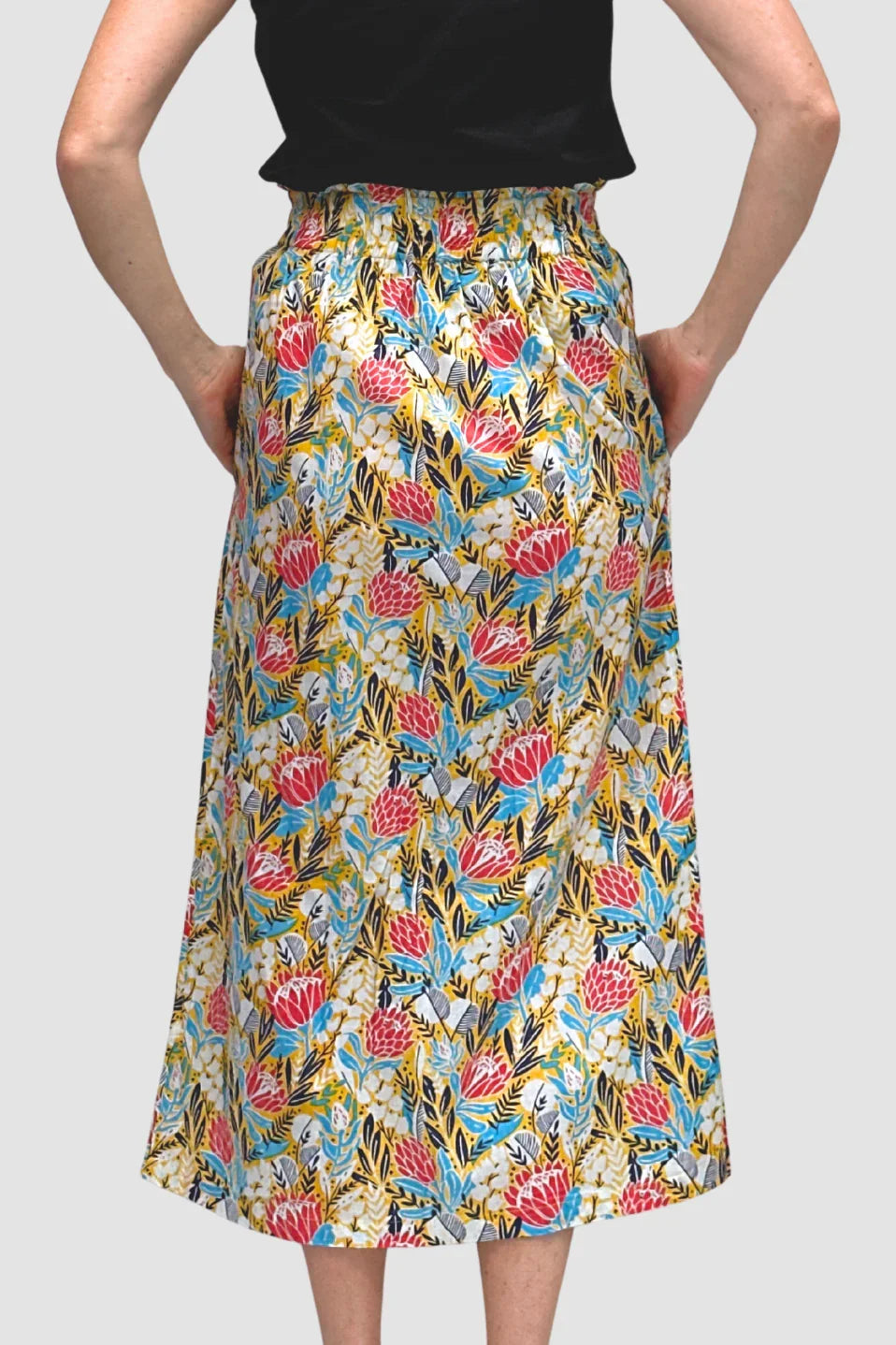 Protea Bloom Skirt skirt worn by a person on a plain background